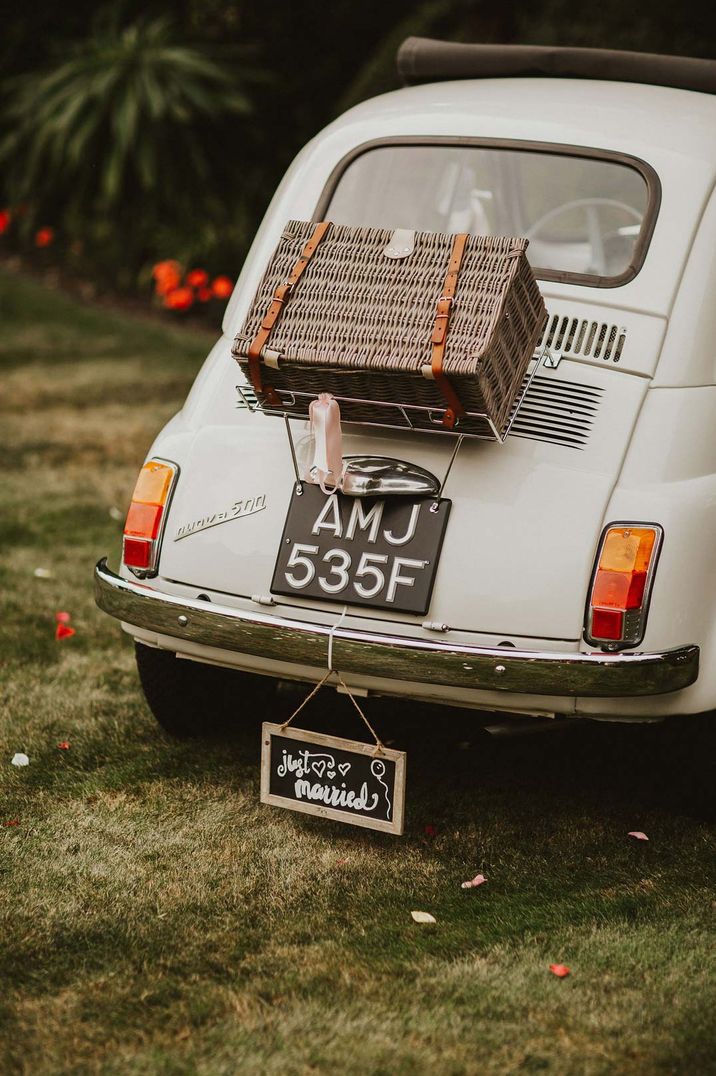 White Fiat 500 with "Just Married" wedding trunk and suitcase decorations