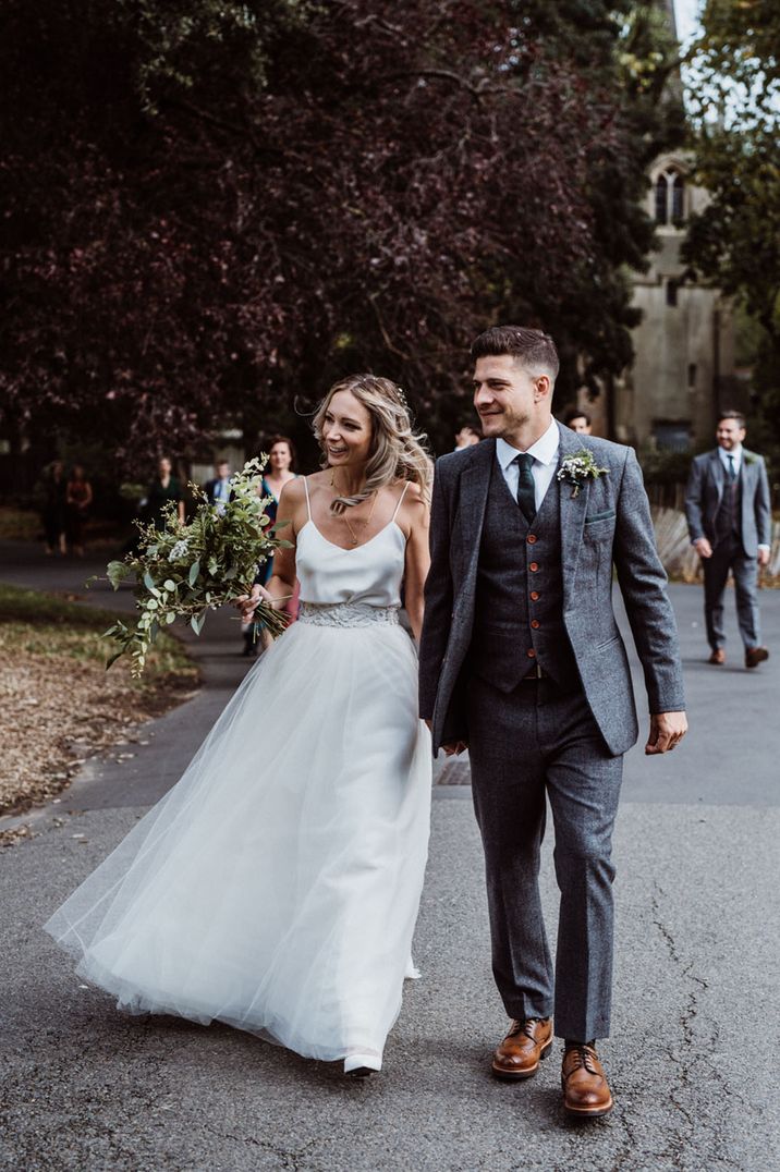 Bride wears embellished bridal belt with silk top and skirt 