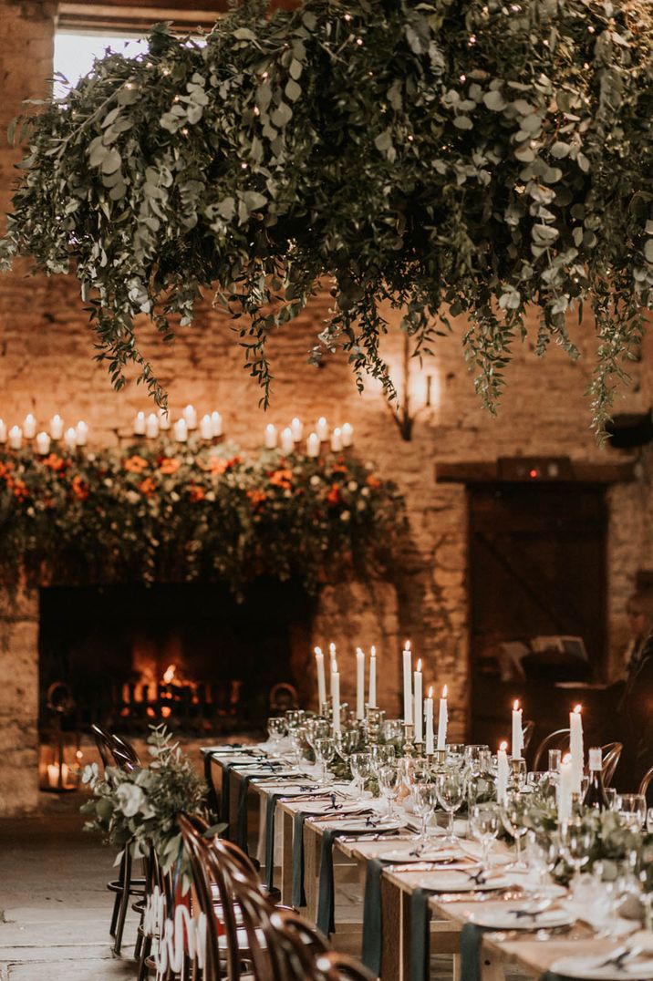 Cripps Barn wedding venue in the Cotswolds with foliage cloud hanging over classic tablescape