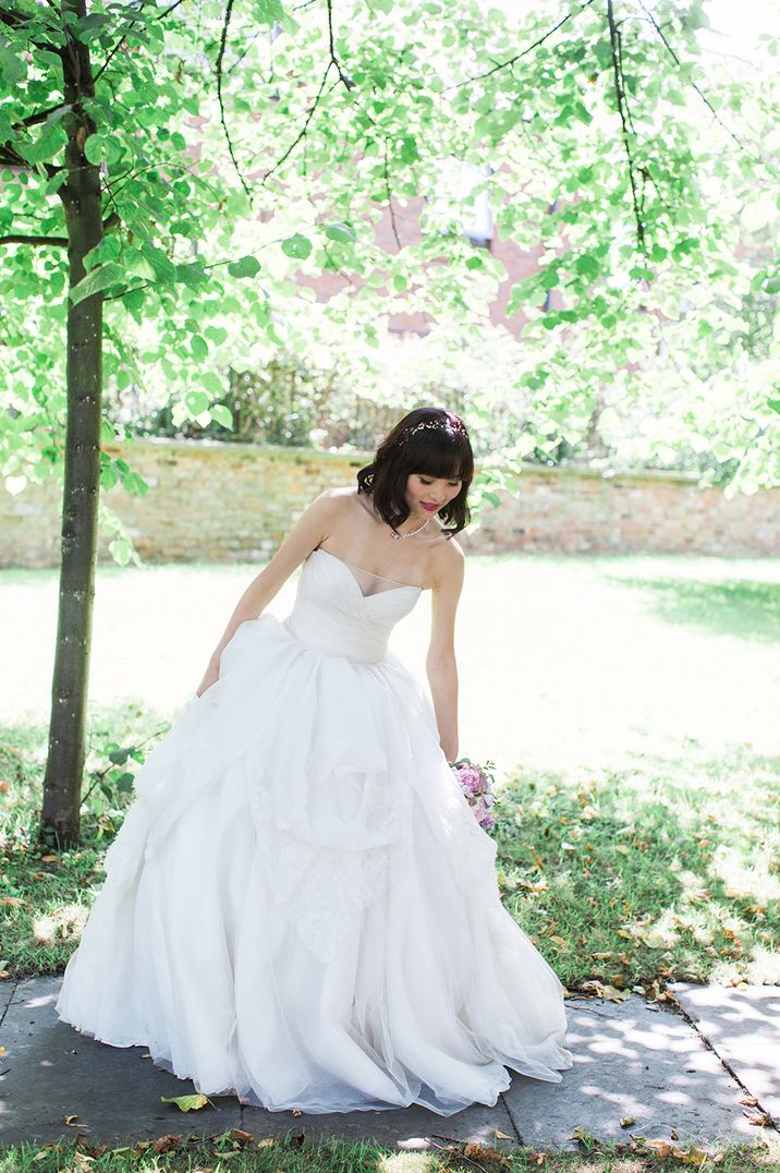 Strapless wedding dress with ruffle skirt by Izzy Norman Photography