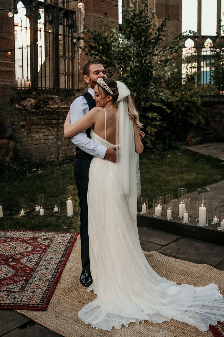 Bride in a romantic wedding dress with an ivory bow wedding veil by Rebecca Anne Designs 