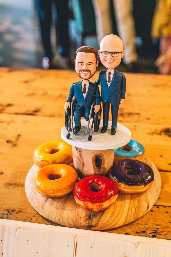 Groom cake toppers on bright doughnuts display