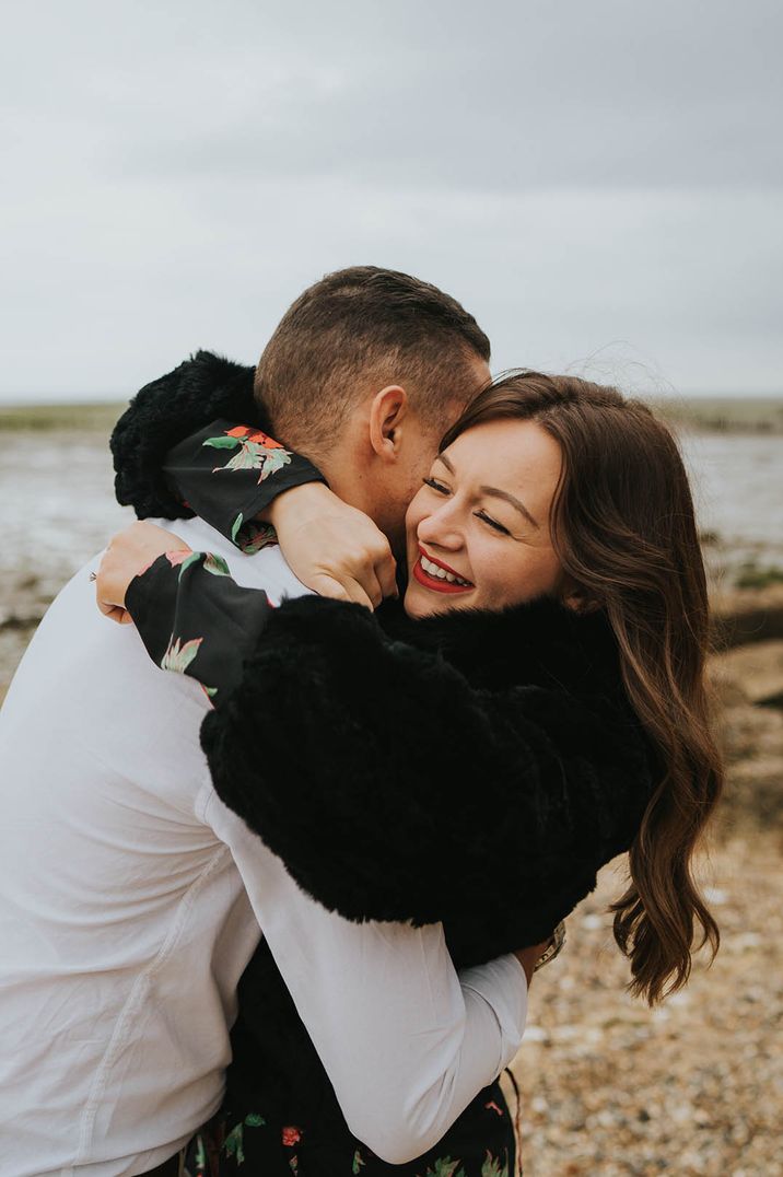 Couple shares an intimate embrace on a beach