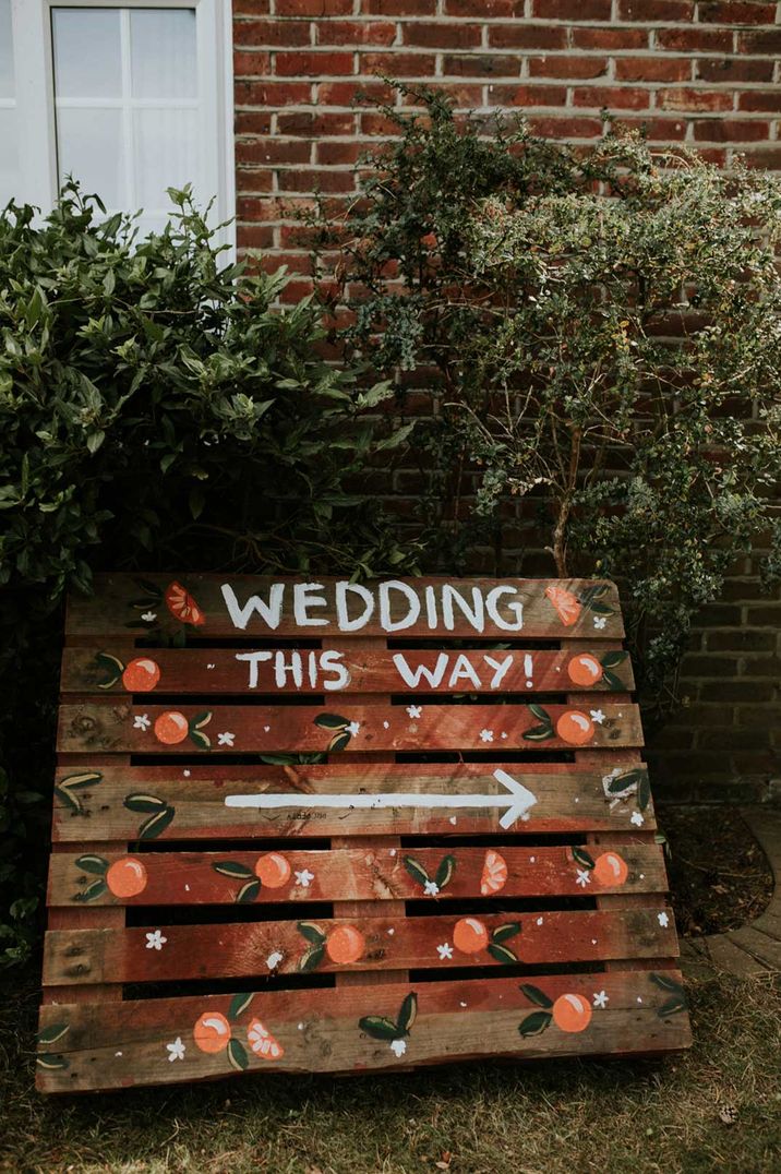 DIY wooden wedding sign with painted on wording and orange details