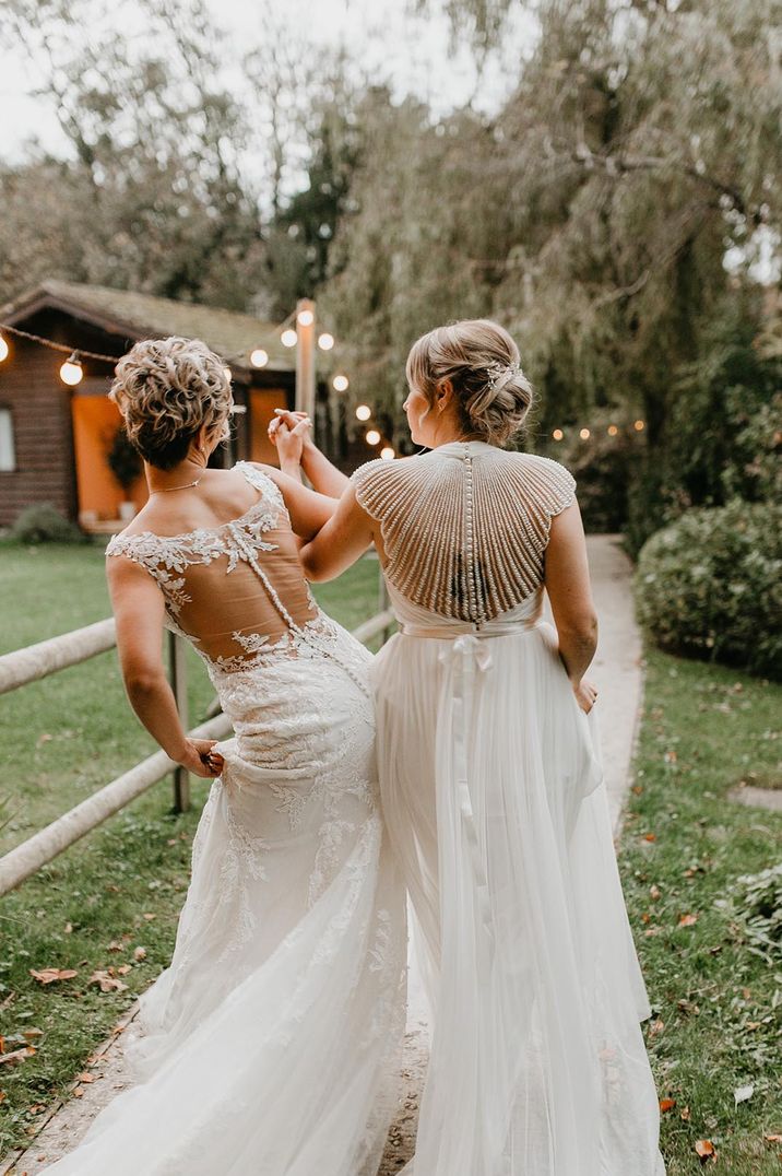 Lesbian wedding with two brides in an illusion back with lace and embellished wedding dress designs 