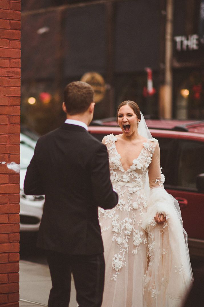 Bride in lace wedding dress drops her jaw to the floor as she sees her groom in funny first look moment 