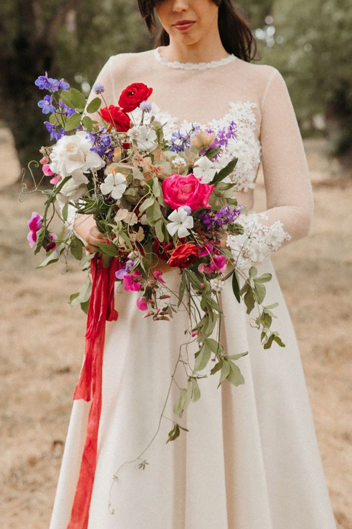 Bright wedding flowers tied with ribbon with natural wildflowers and foliage to create that summer seasonal effect 