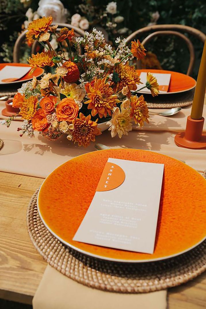 Orange tablewear and decor including plates and flowers by Annie Poe Photography 