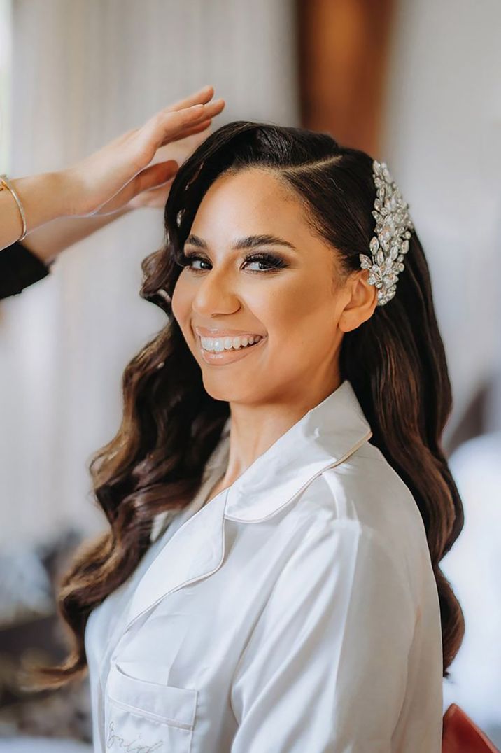 Bride with side swept hair styled with a diamond hair accessory