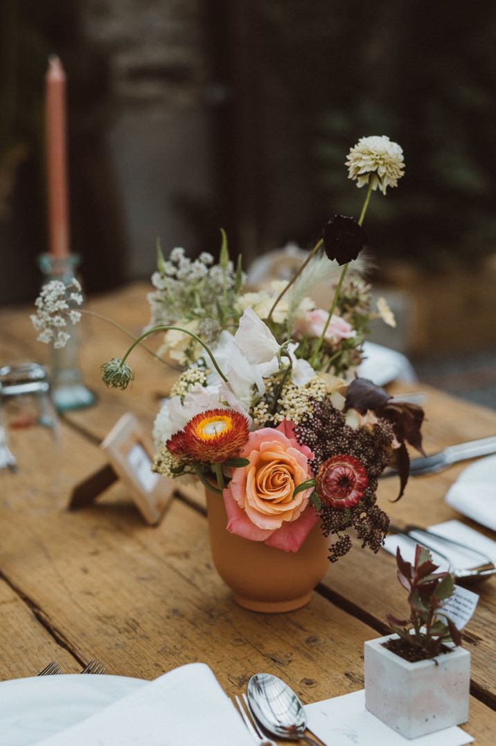 Colourful wild flower in a terracotta pot for a boho wedding in Devon