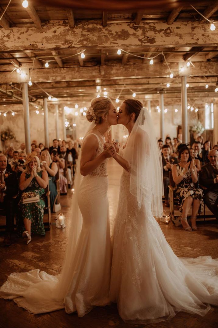 Brides kissing at the alter at Holmes Mill Disney themed wedding