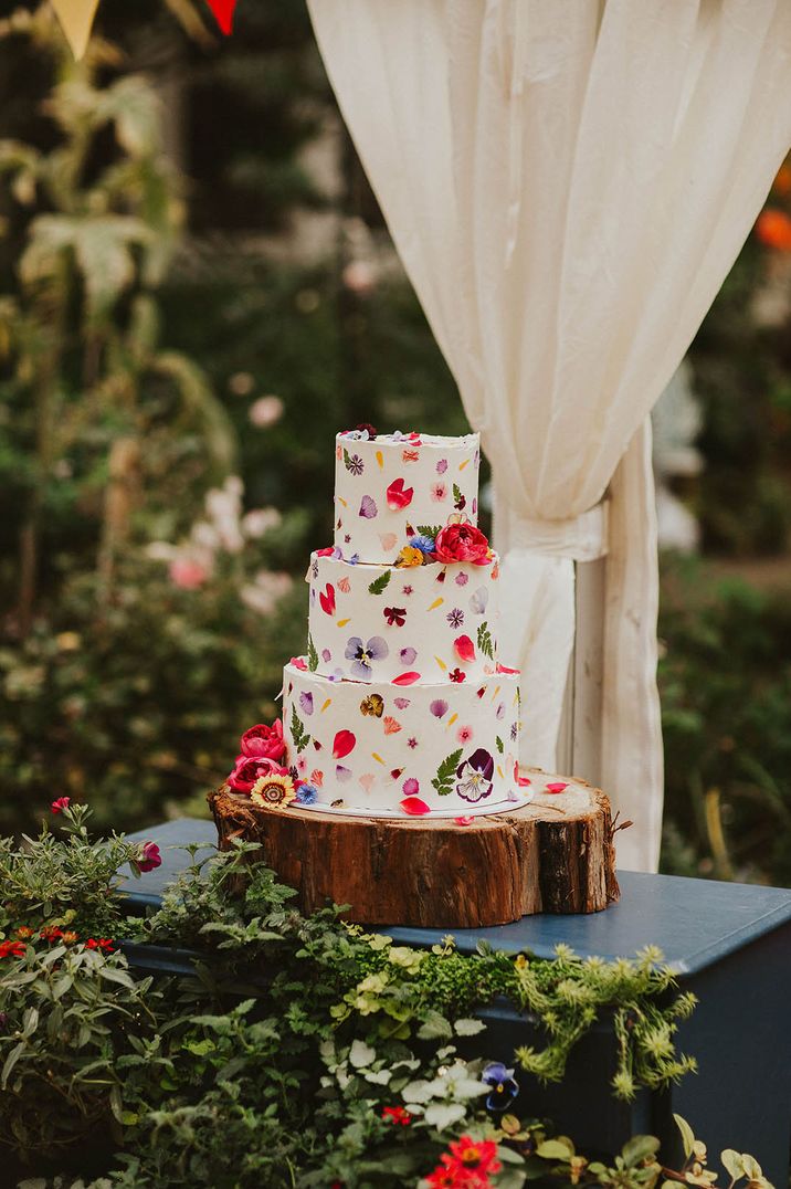 rustic wedding cake with buttercream and edible flower decoration 