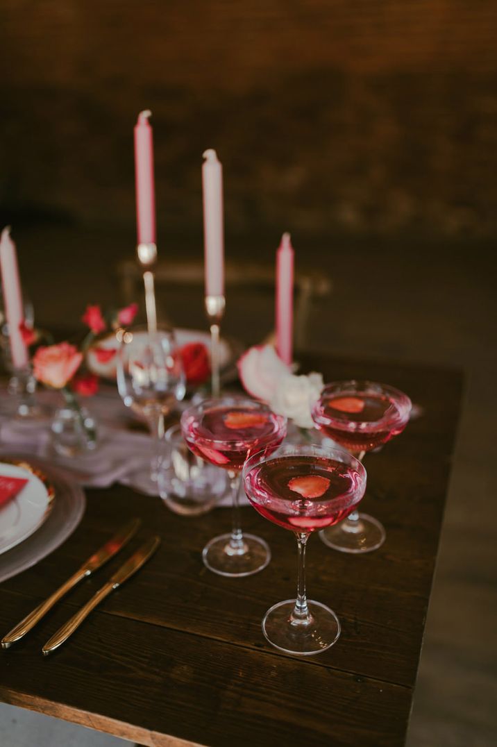 Pink themed tablescape with pink signature cocktail drinks with strawberries 