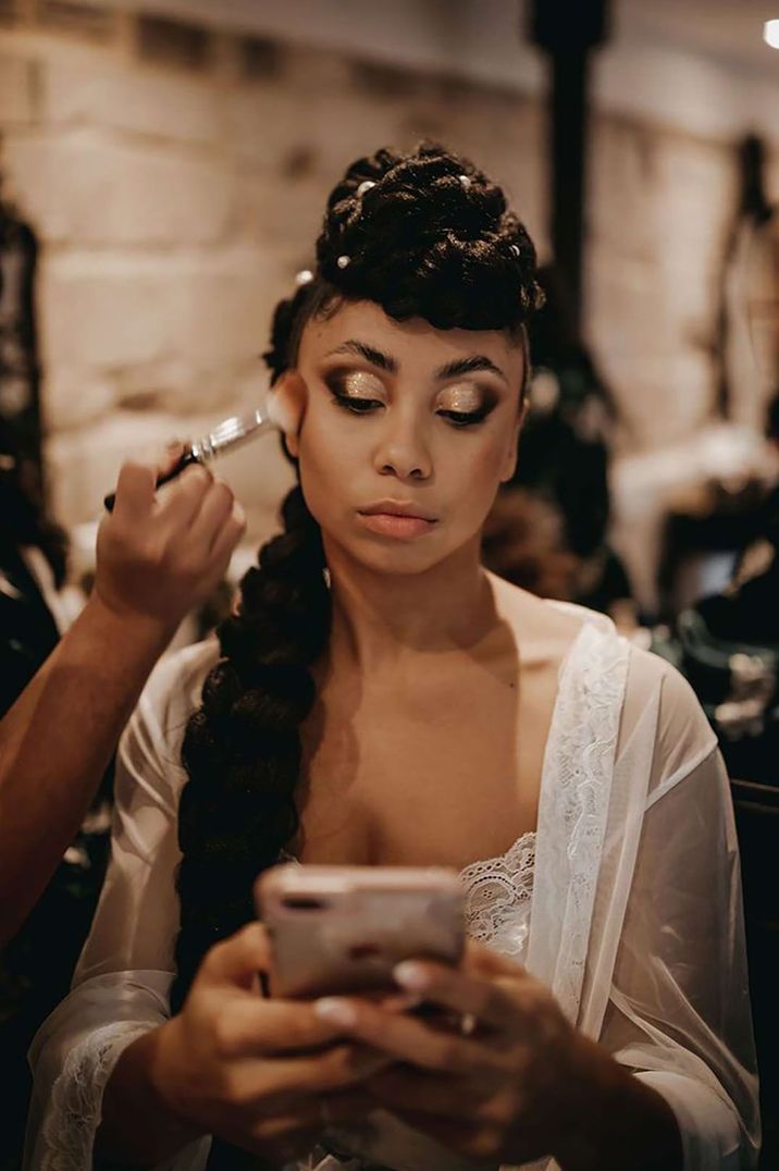 Bride with smokey eye makeup with hair in giant braid with pearl hair pins