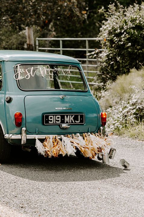 Baby blue wedding car with bunting decoration