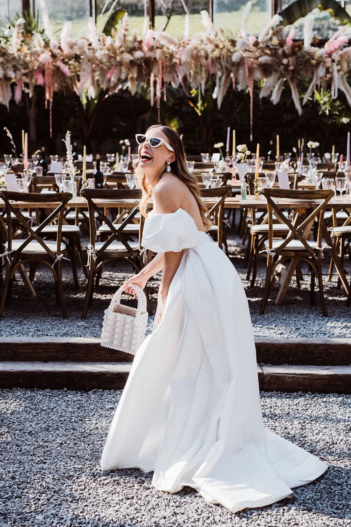 Bride holds pearl embellished handbag 