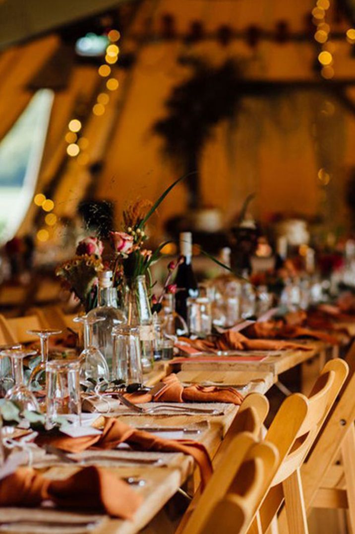 Warm toned orange wedding tablescape with orange napkins at the Lake District wedding venue 