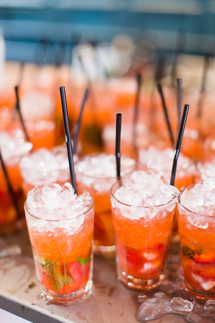 Strawberry mojito cocktails with strawberries, mint and crushed ice with black straws 