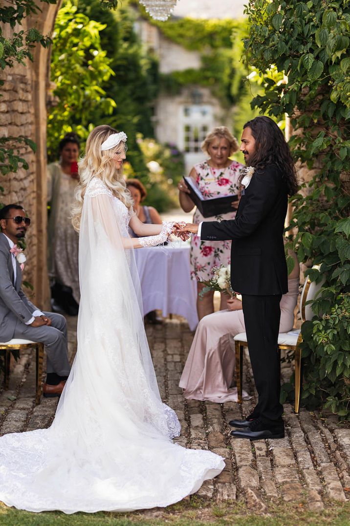 Apache blessing at Euridge Manor with bride in a lace Wona Concept wedding dress and Indian groom in a black tuxedo 