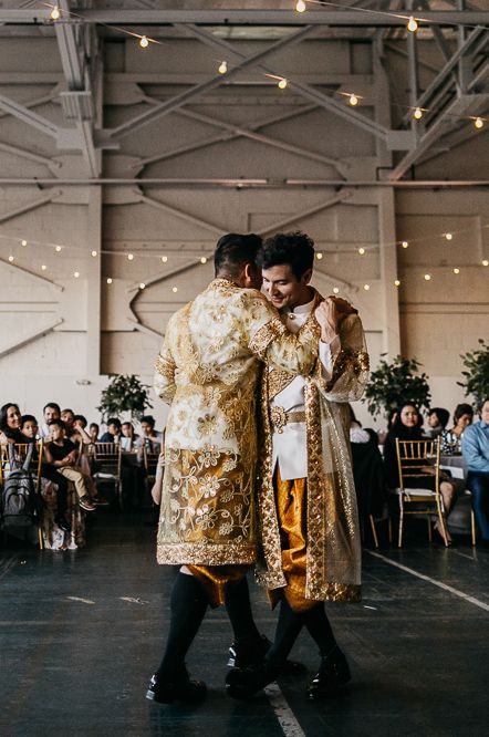 Two grooms in traditional white and gold Cambodian outfits perfect for gay wedding inspiration