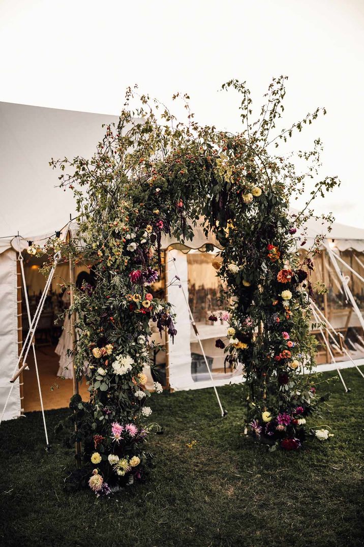 DIY fauna and floral arch outside marquee at DIY marquee wedding