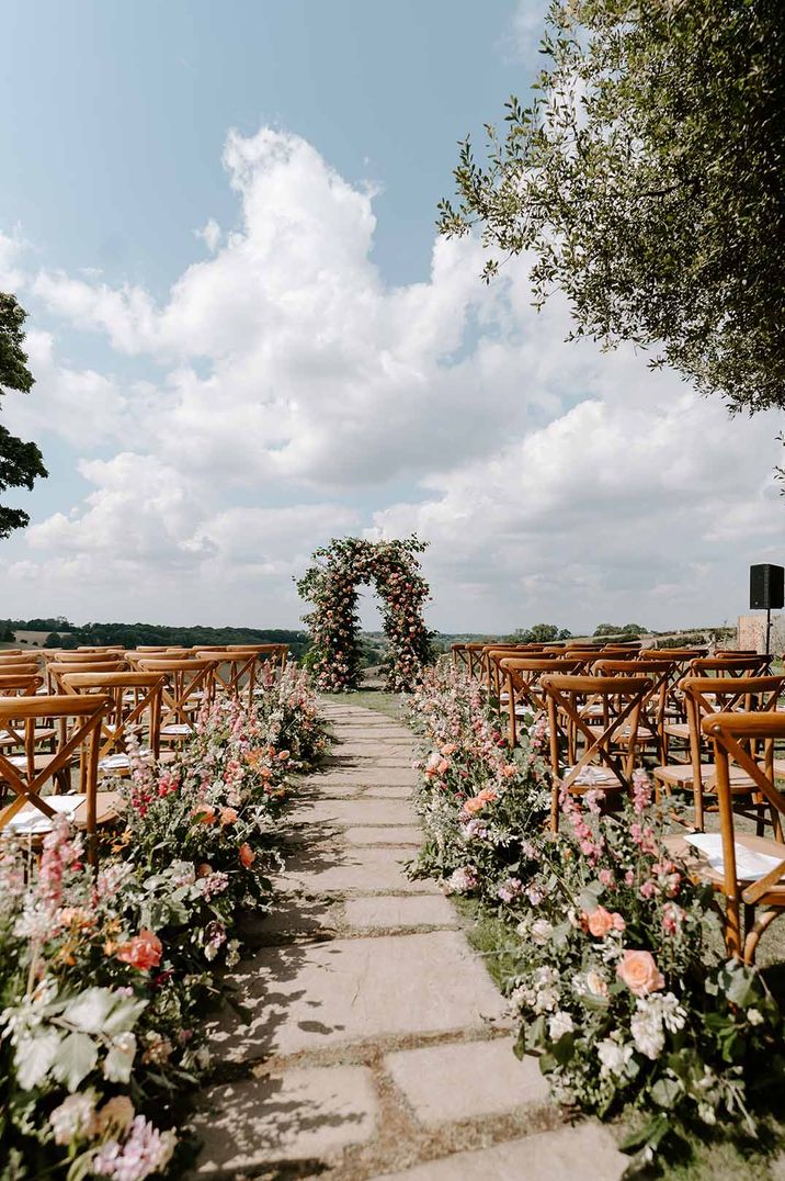 Outdoor wedding aisle and altar flower arch wedding flower arrangements 