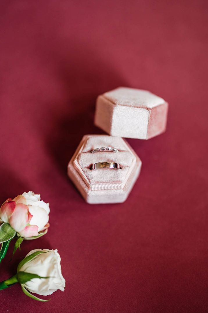 Pale pink ring box with diamond wedding ring and chunky silver wedding band 