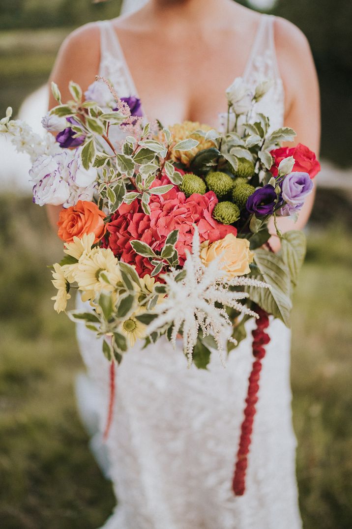 Brightly coloured wedding bouquet with hydrangea, roses, daises and foliage