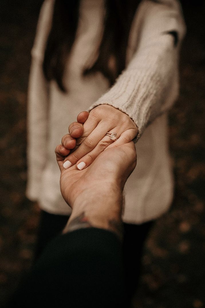 Woman showing off her engagement ring after romantic wedding proposal 