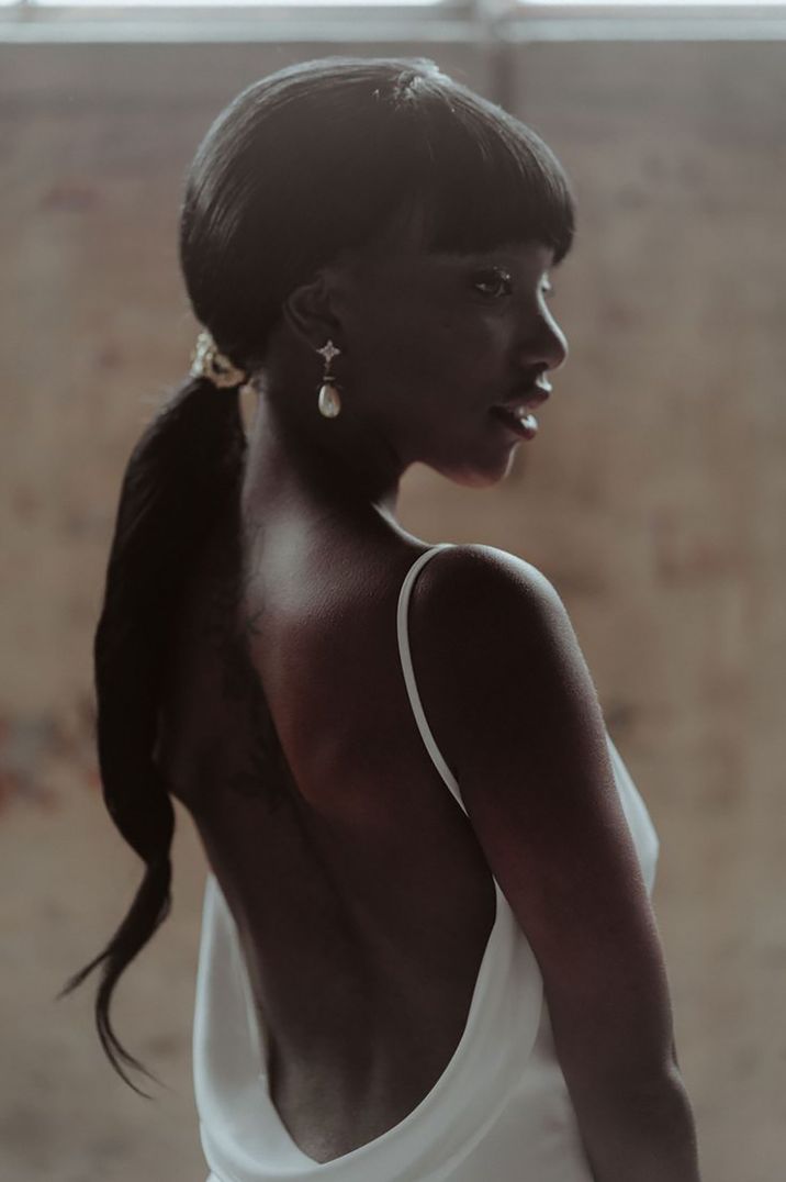 Bride wearing her hair in a sleek ponytail hairstyle 