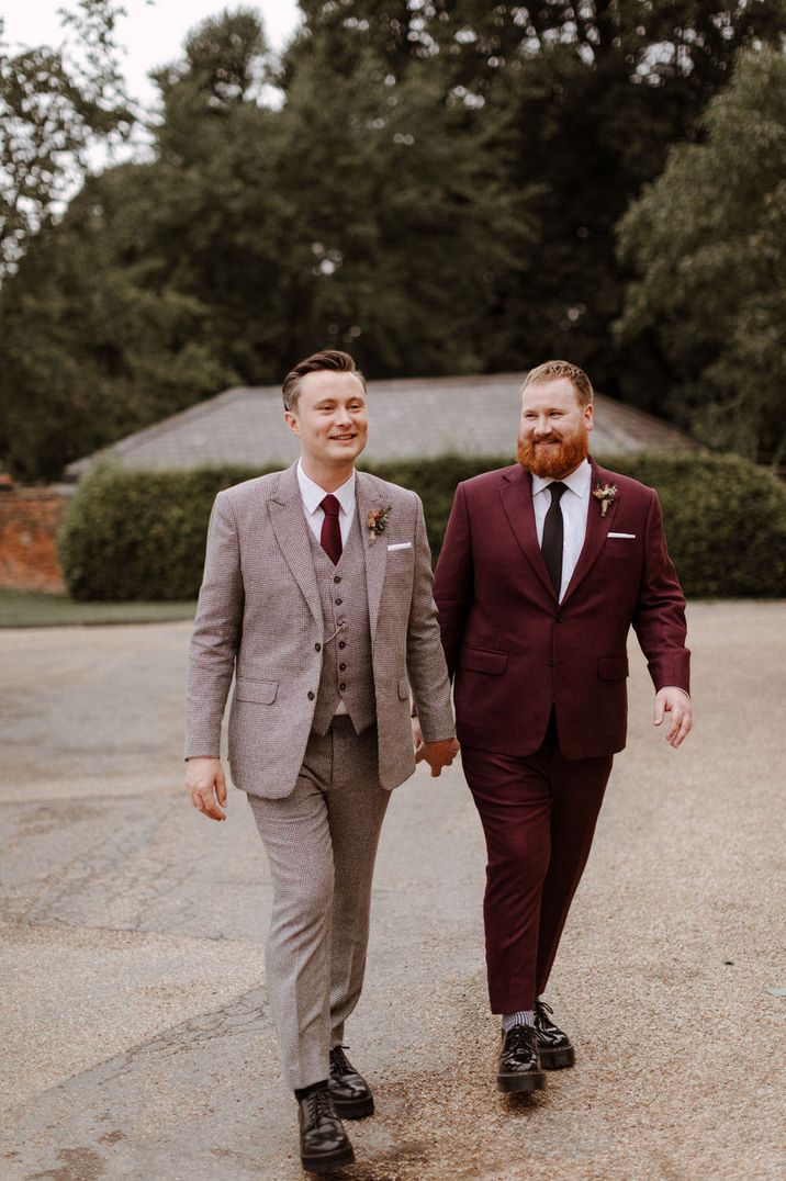 Two groom in in check and burgundy suits at orangery wedding 