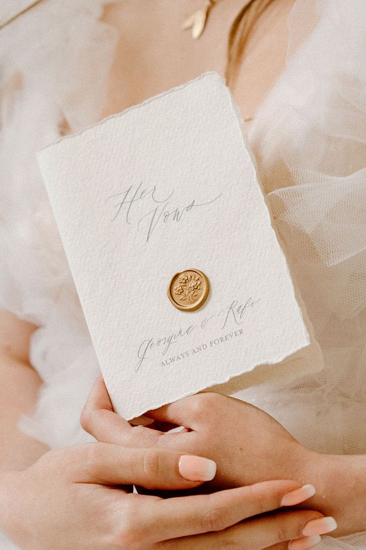 Elegant wedding vow booklet with cursive calligraphy and aged edges with wax seal