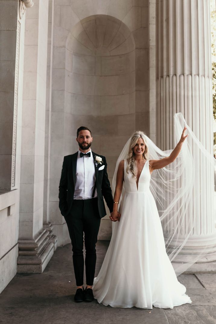 Old Marylebone Town Hall intimate wedding with bride in a princess wedding dress and groom in a tuxedo 