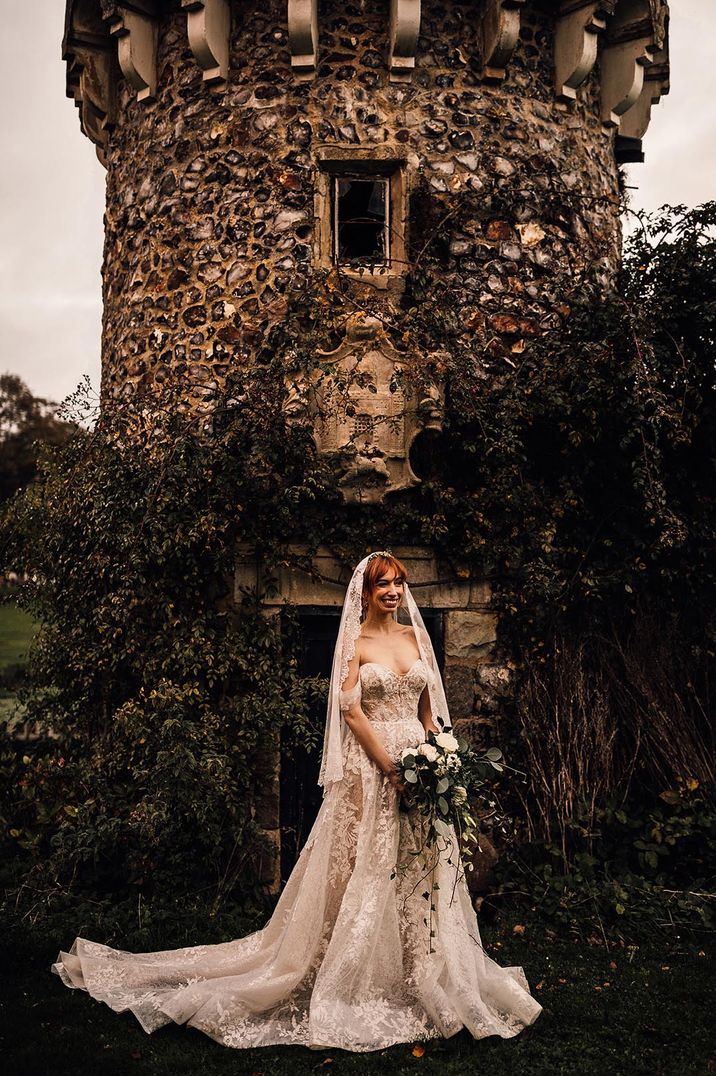 Bride in strapless Martina Liana wedding dress with embroidered edge fingertip length veil 