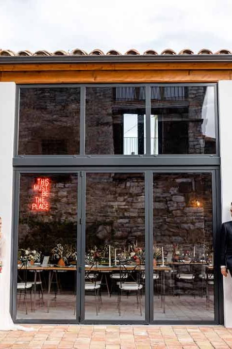 Bride and groom standing outside of Barcelona destination wedding venue This Must Be The Place - one of the most Instagrammable wedding venues 