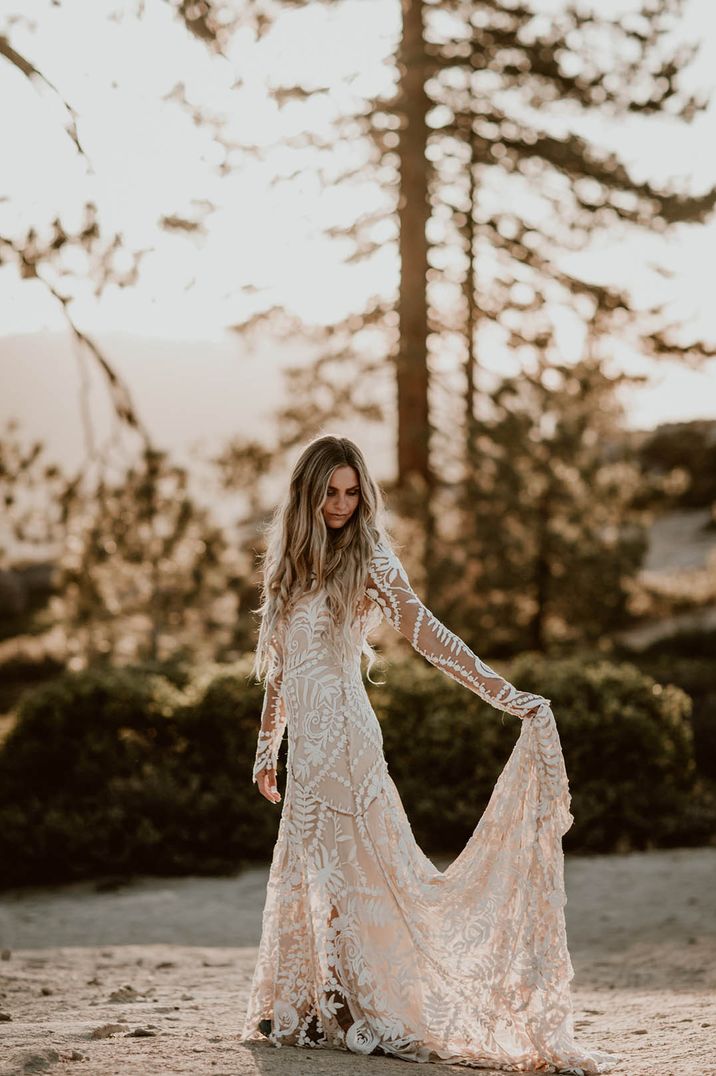 Bride wearing long sleeve lace wedding dress with train 