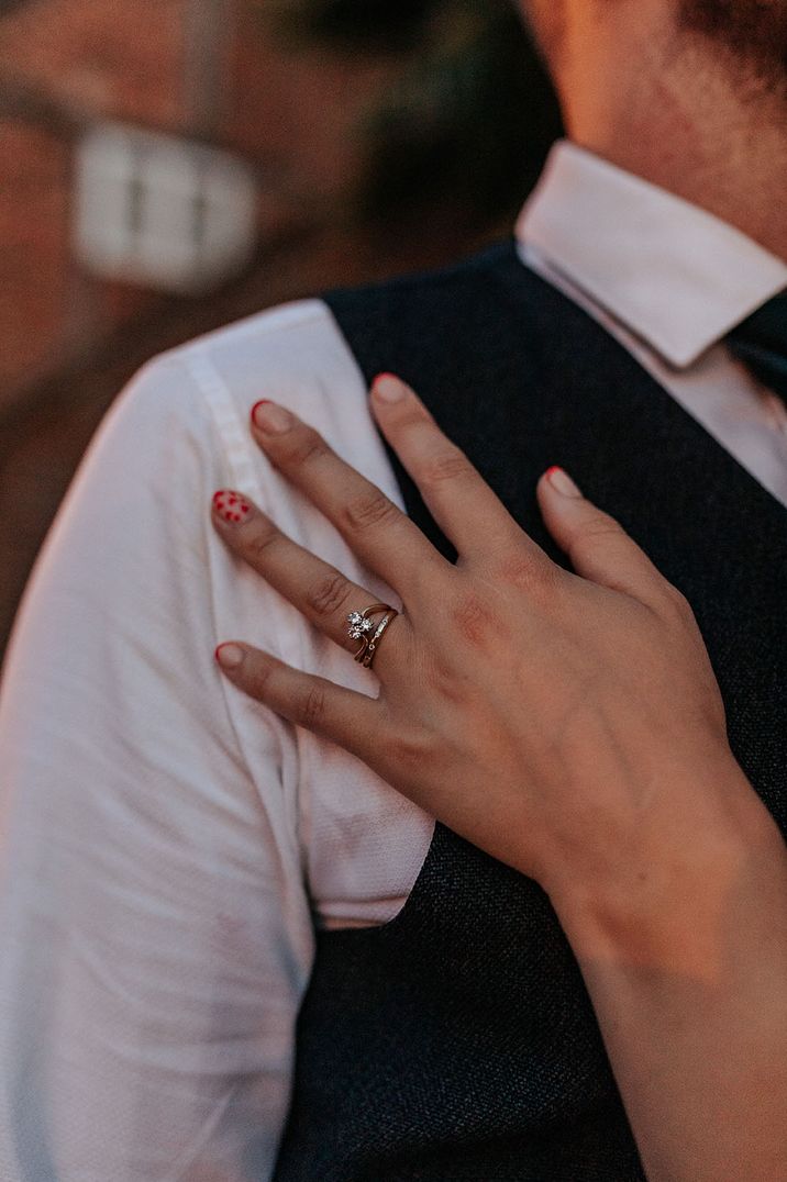 Bride with red wedding nails with diamond engagement ring 