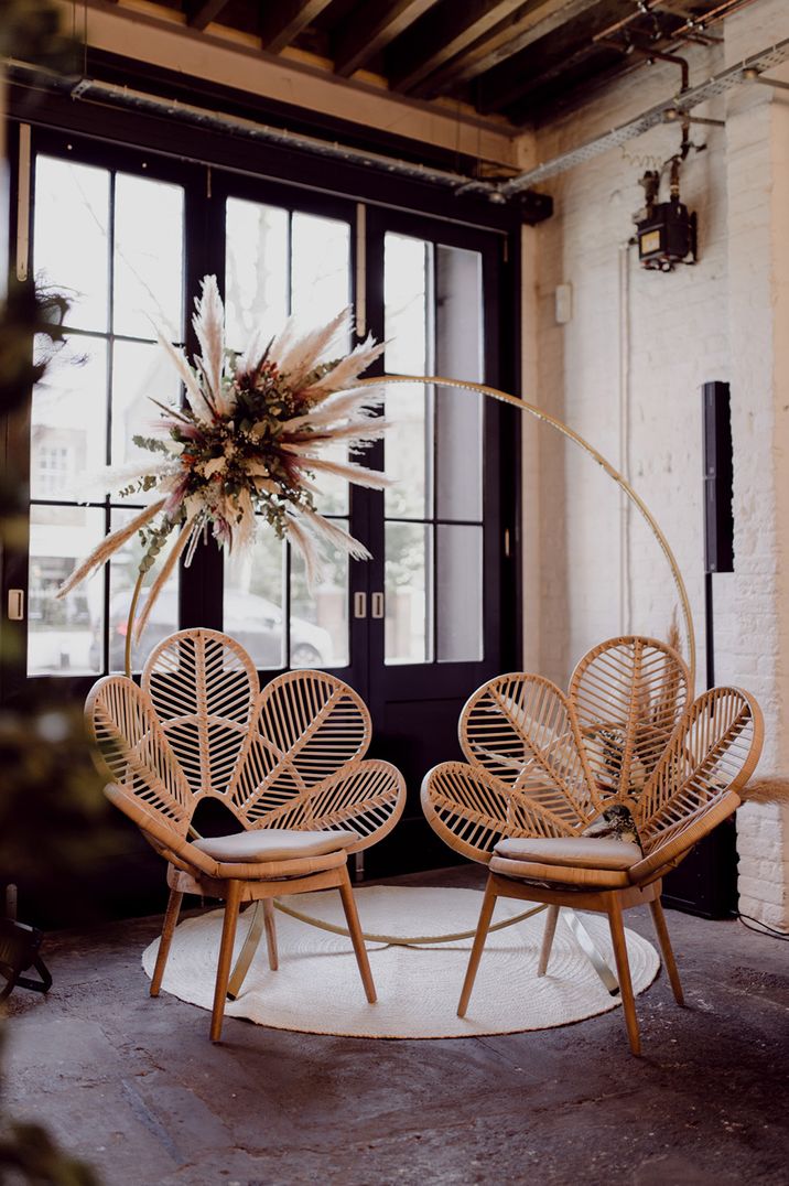 Wooden Moorgate private seating area with dried flower decor and two wooden flower rattan chairs