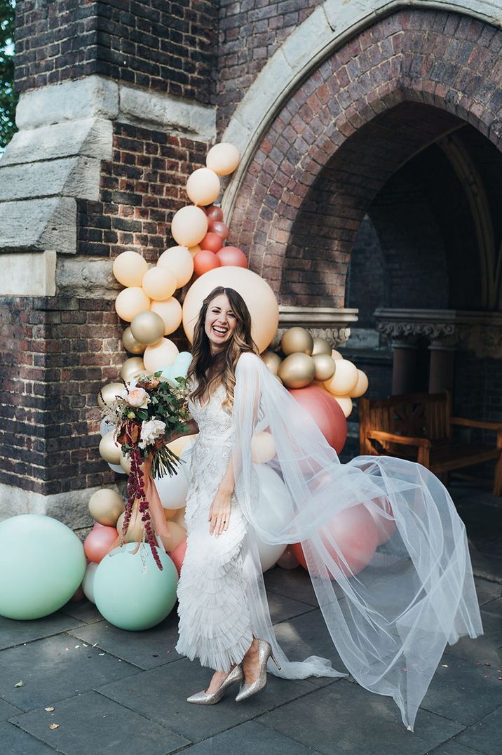 Bride wears sheer bridal cape and tulle wedding dress 