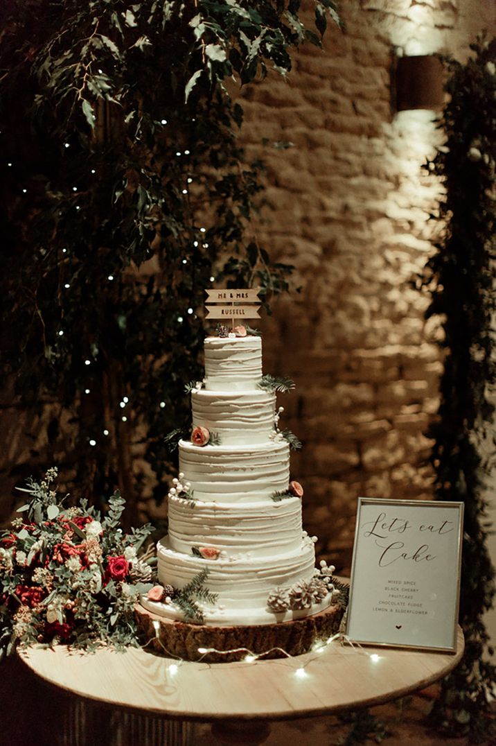 Epic five tier white iced winter wedding cake with custom cake topper 