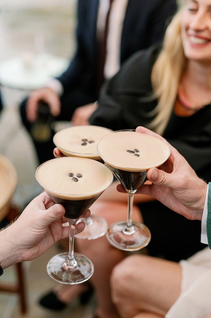 People making a toast with their cocktails of espresso martini at London cocktail bar 