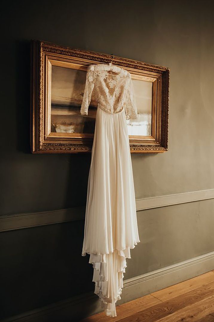 Boho style wedding dresses hanging on padded hanger | Paige Grace Photography