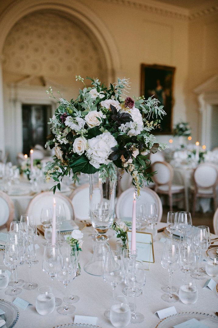 Tall white and green floral centrepiece with hydrangeas, roses and foliage 