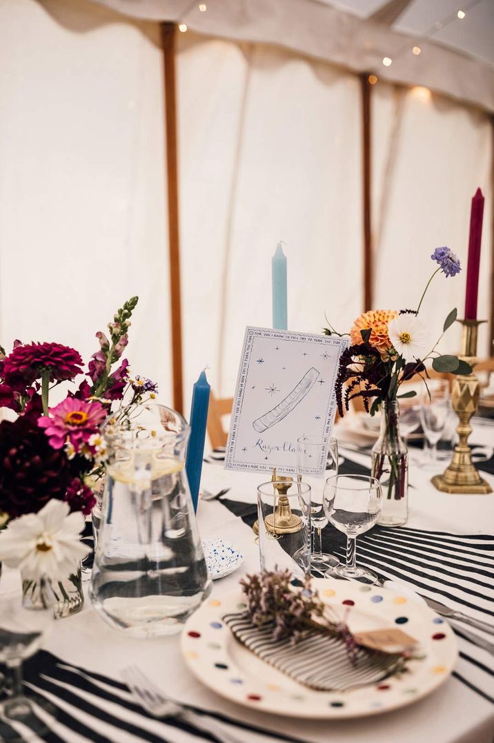 Colourful wedding tablescape with pops of blue, yellow and stripes and DIY table numbers