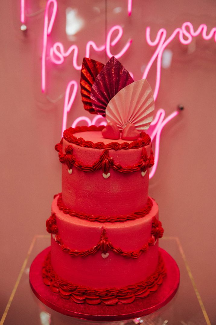 Retro style two tier magenta wedding cake in the Pantone Color of the Year 2023 