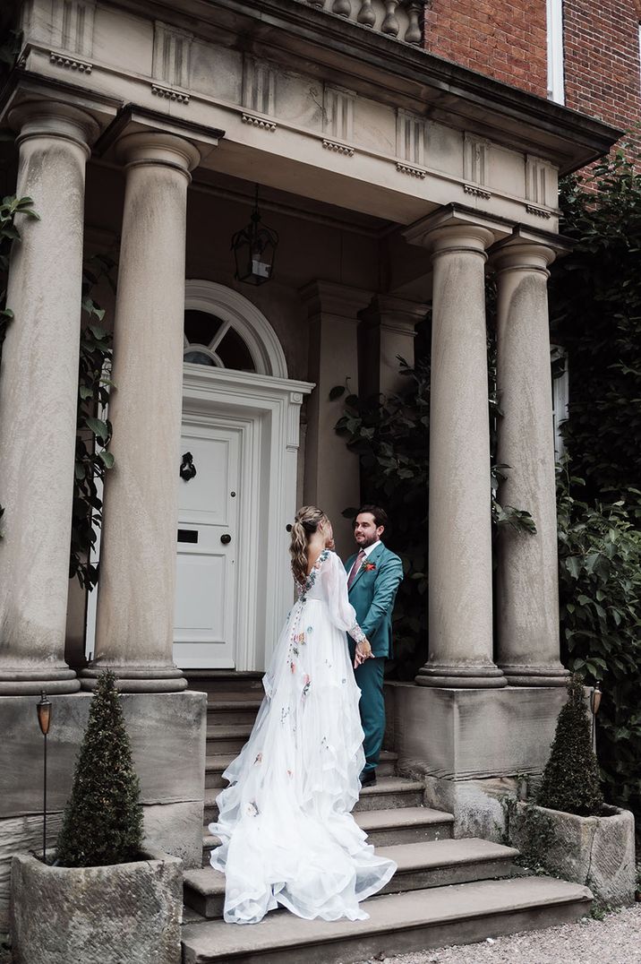 Country house wedding venue, Iscoyd Park with the bride and groom posing for couple portraits at the entrance 