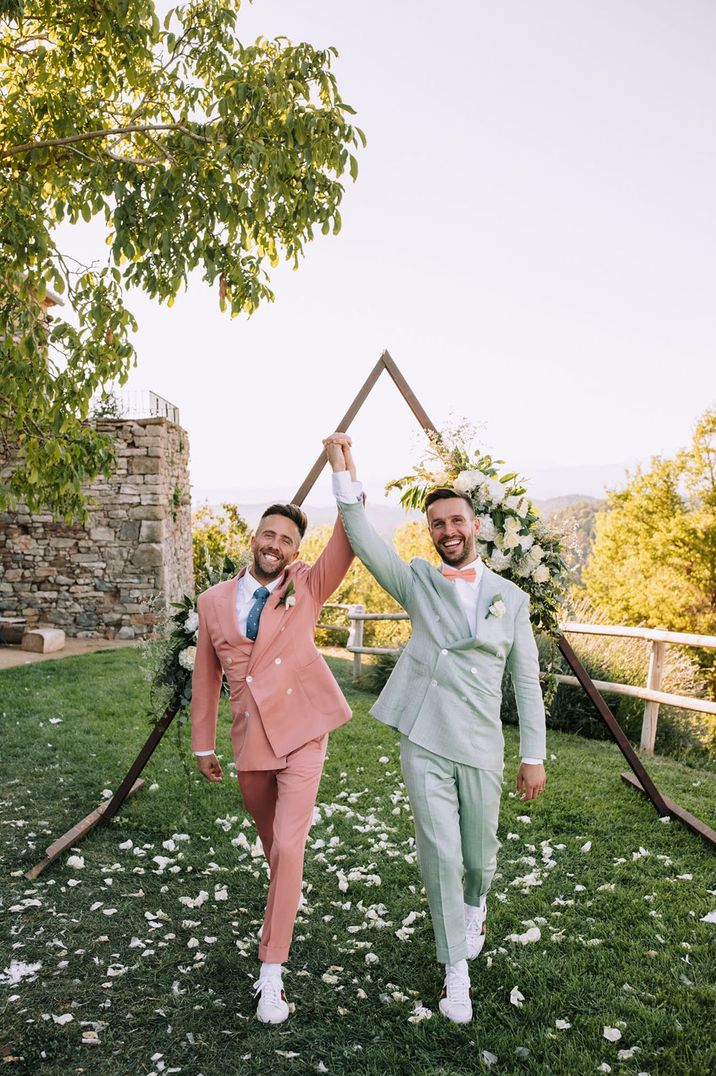 Two grooms in colourful suits at LGBTQIA+ wedding at destination wedding venue in Barcelona