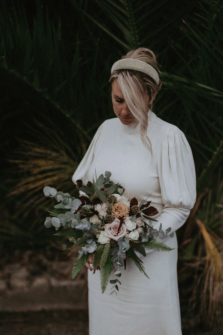 Bride in a long sleeve wedding dress with blouson sleeves and fitted cuff detail