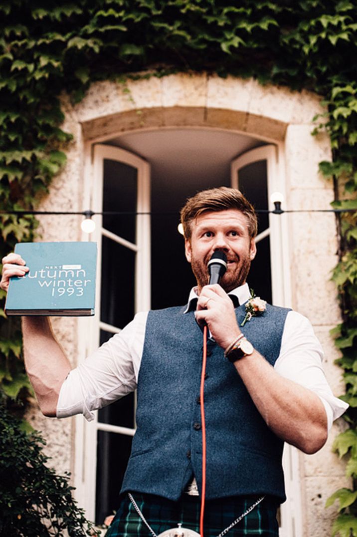 Groom in blue waist coat at destination wedding giving a groom speech