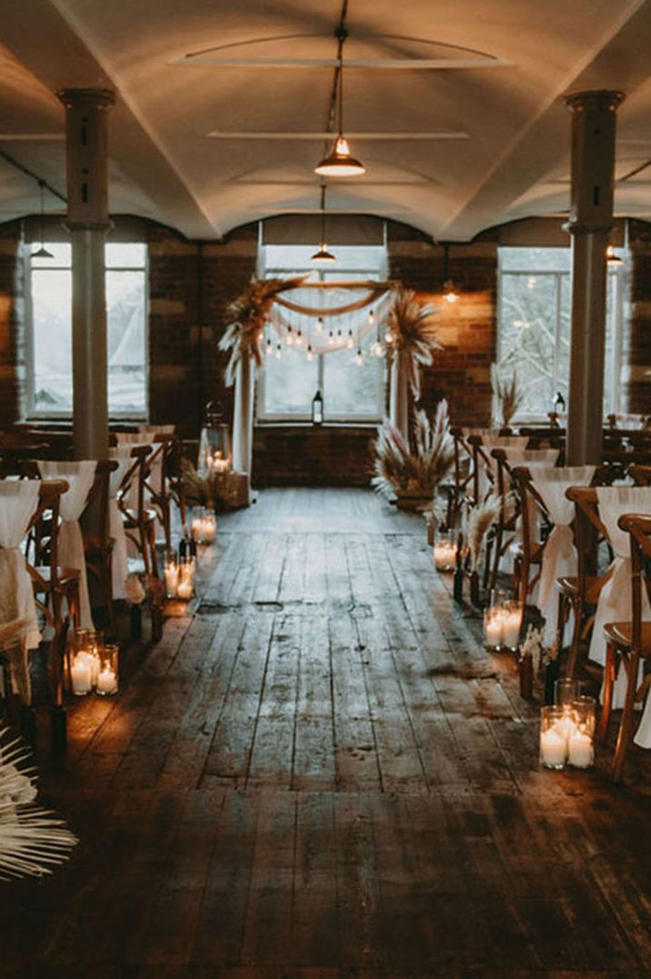 The aisle and altar at this Yorkshire wedding venue decorated in autumnal seasonal flowers and decor 